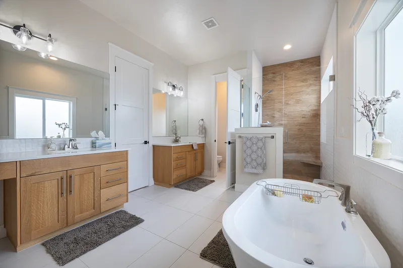Listing Photo of a modern bathroom showcasing a walkin shower, soaker bathtub, double vanity, and beautifull marble tile floors.