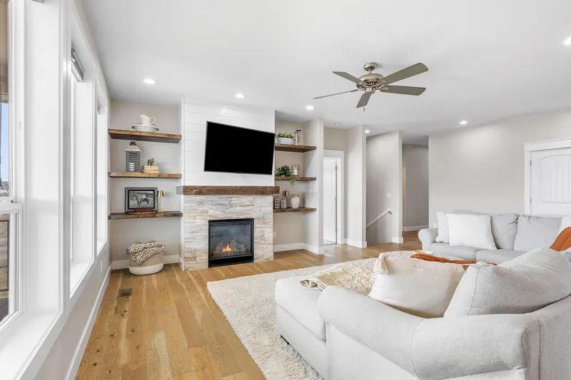Modern living room in a Caldwell, Idaho home, featuring a shiplap fireplace, built-in shelving, and a bright open layout—ideal for real estate and short-term rental listings.